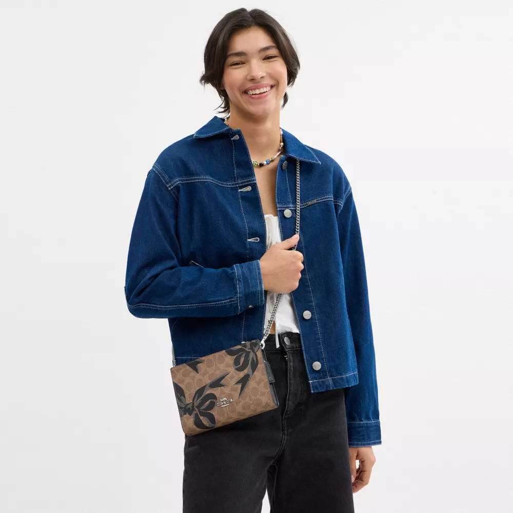 Slim Crossbody Bag In Signature Canvas With Bow Print