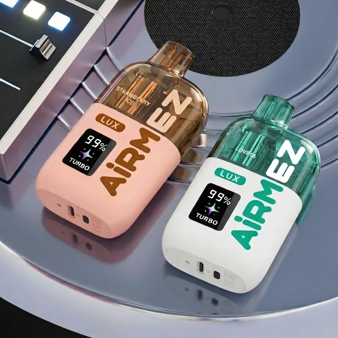Airmez Lux 60K disposable vapes (Strawberry Ice and Love 66 flavors) on a reflective surface with a mixer background.