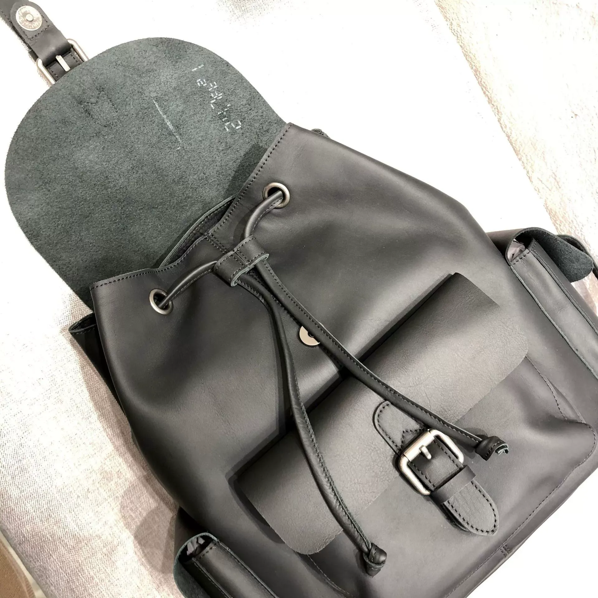 Genuine Leather Backpack with Flap and Drawstring Closure